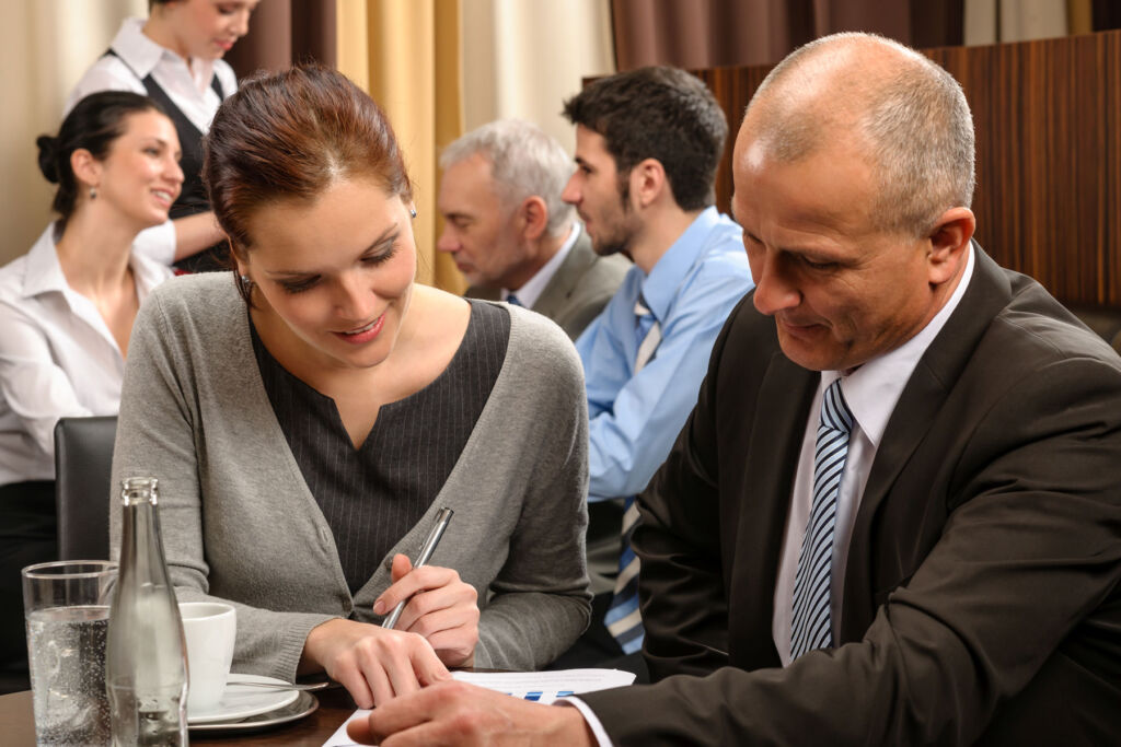 A young woman and an older man having a business meeting