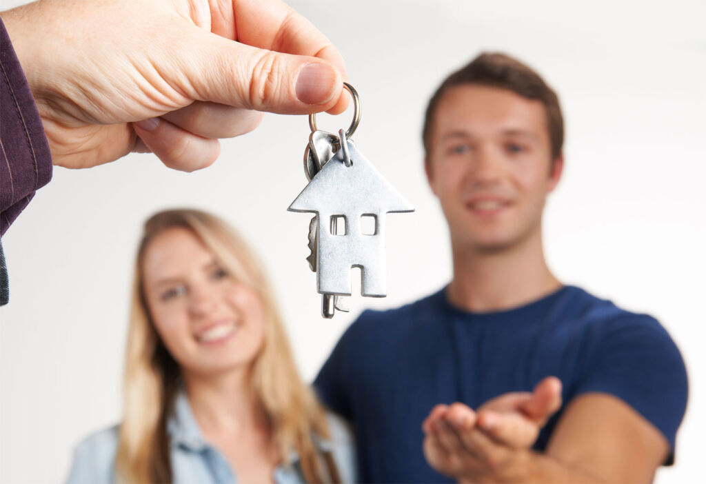 Young couple getting keys to first property