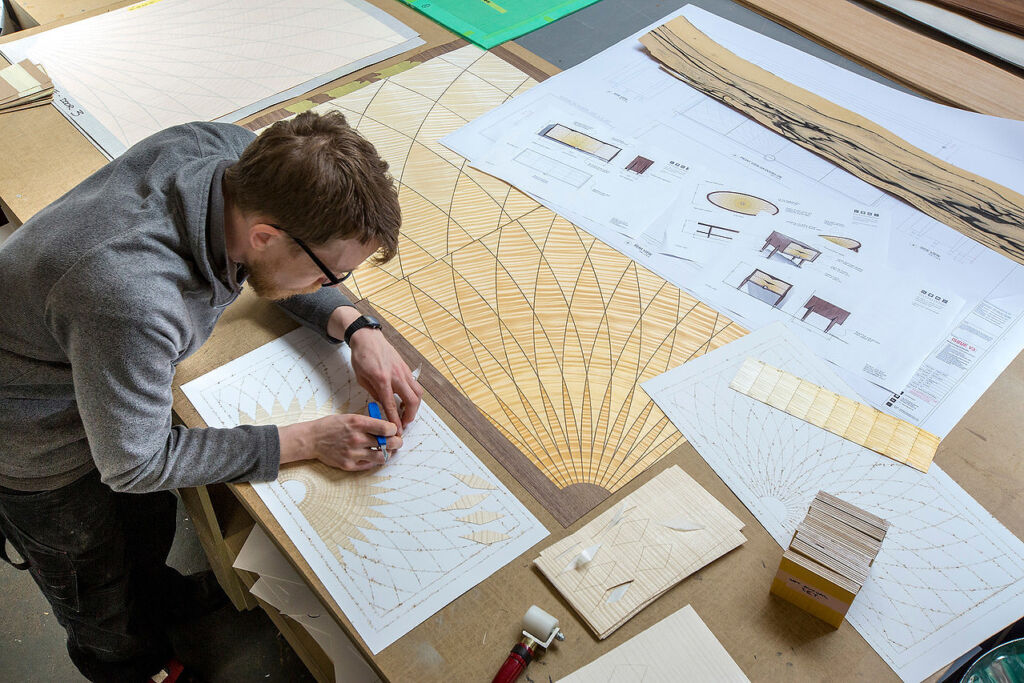 One of the designers working on a wooden marquetry pattern