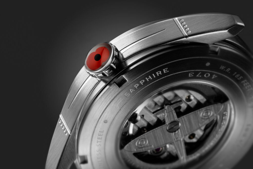 A closeup of the poppy on the crown of the watch