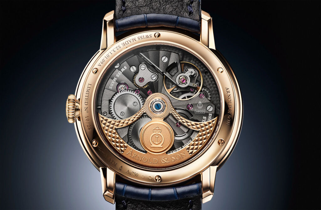 A closeup view of the rear of the watch showing the gold movement