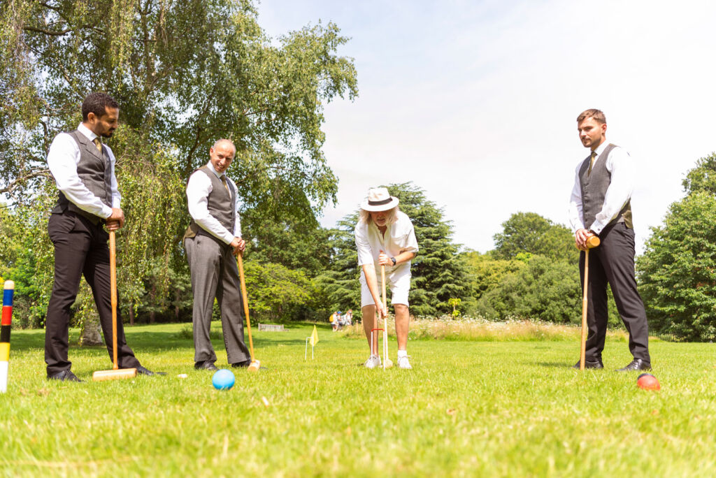 Staff being trained in the sport of croquet