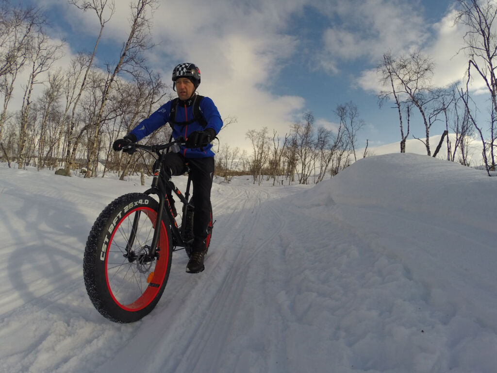 A man riding a Fatbike through the snow