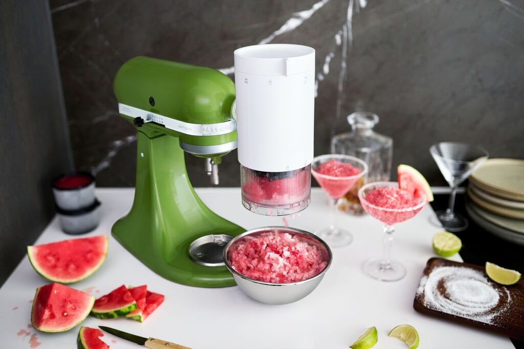 https://www.luxuriousmagazine.com/wp-content/uploads/2022/07/KitchenAid-mixer-with-Shave-ice-attachment-making-watermelon-margueritas-1024x683.jpg