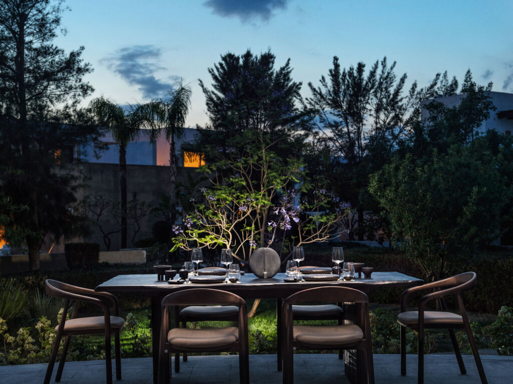 A private outdoor dining table at sunset