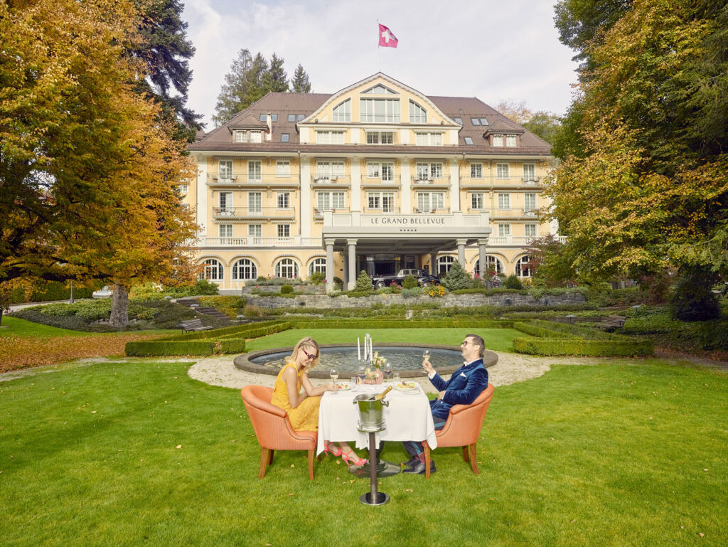 A couple enjoying champagne in the hotel grounds