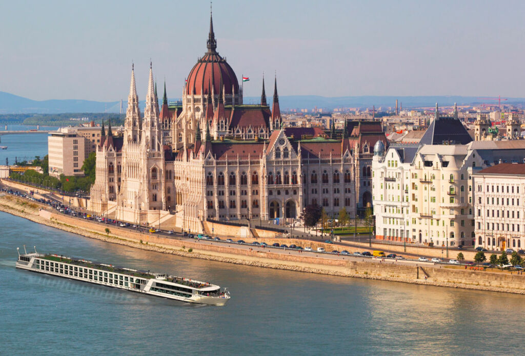 One of the ships sailing past historic buildings in Hungary