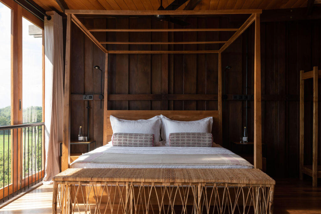 One of the wooden four-poster beds inside the property