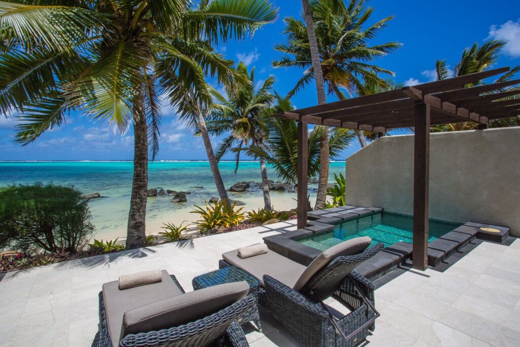 Sun loungers by the beach at Te Manava Luxury Villas & Spa