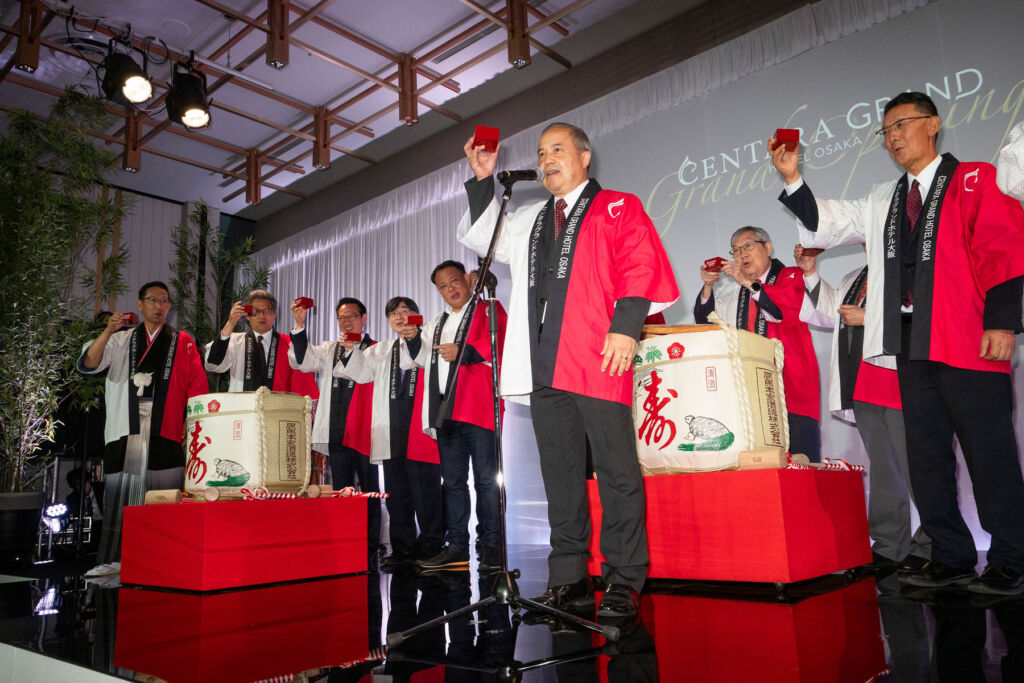 Attendees making a sake toast at the official opening