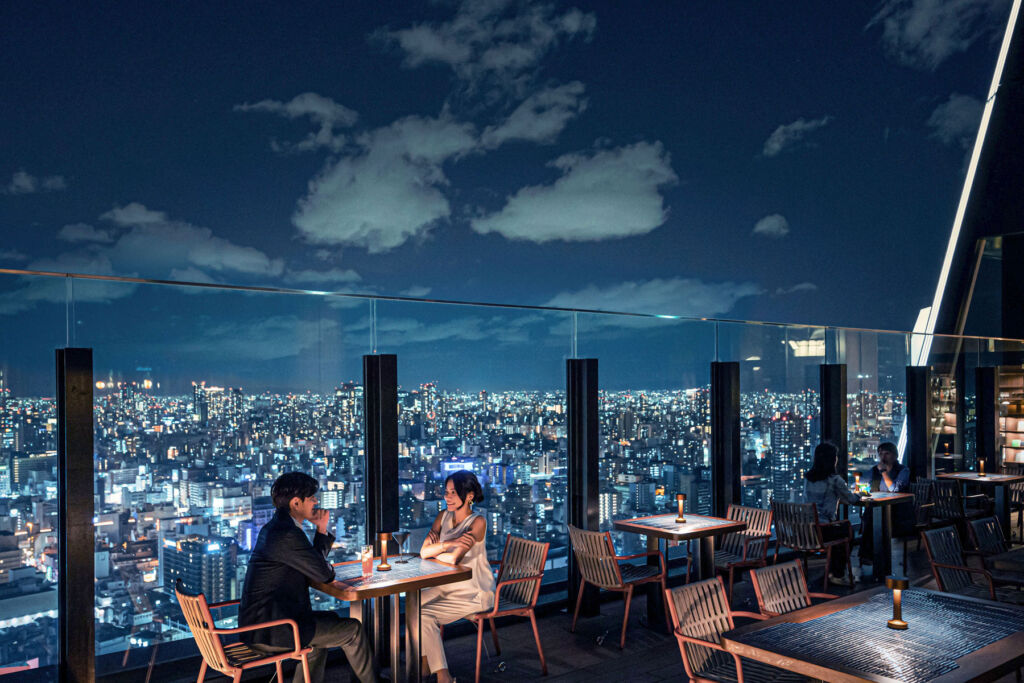 A couple having a meal and enjoying the incredible views from the roof top