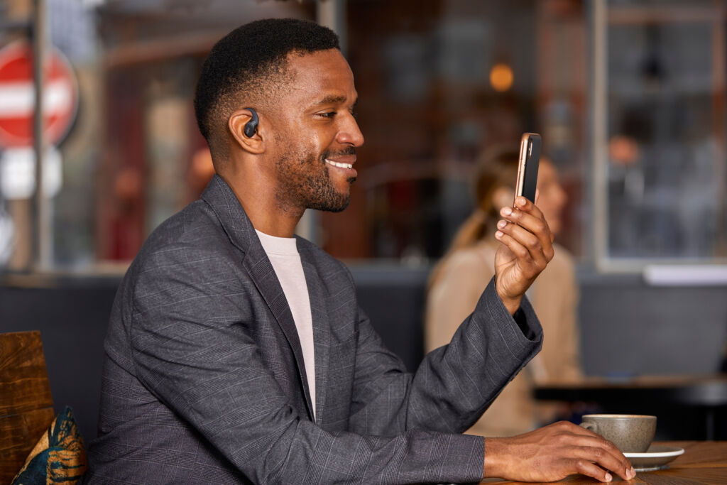 A man talking on the phone in a coffee shop