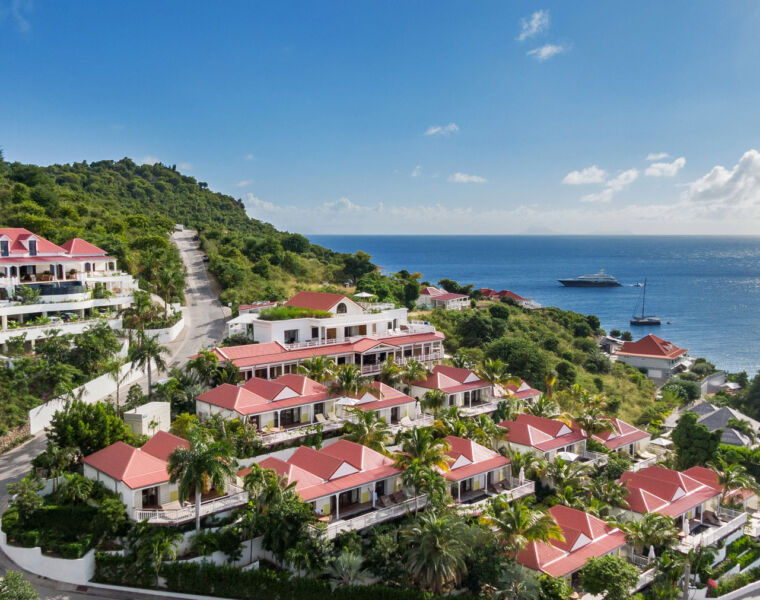 A view of the resort with the sea and blue sky behind it