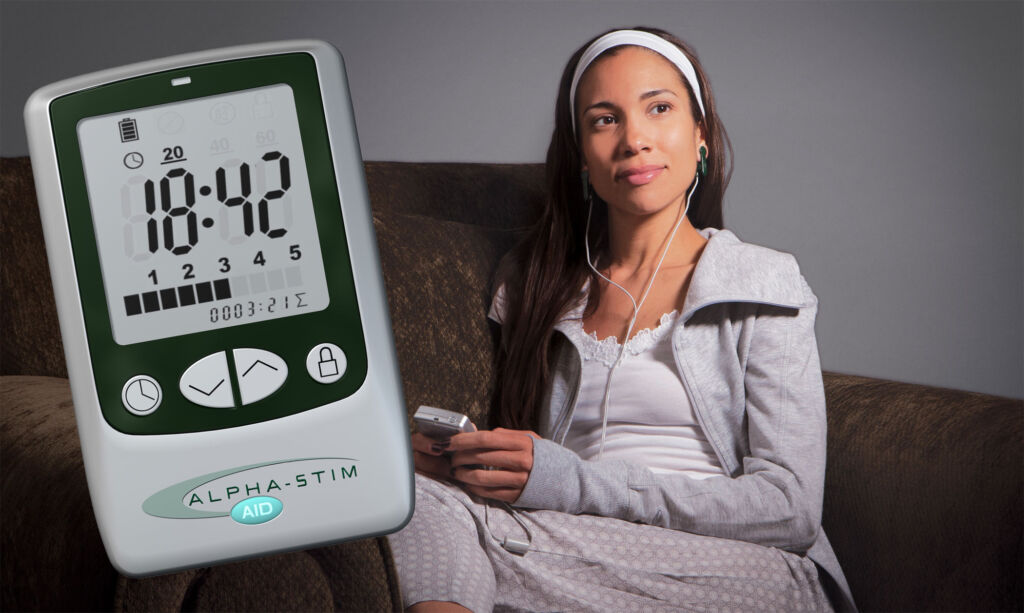 A woman using the Alpha-Stim in her living room