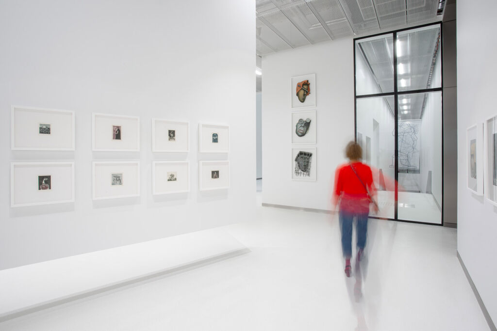 A visitor browsing some of the artworks on display