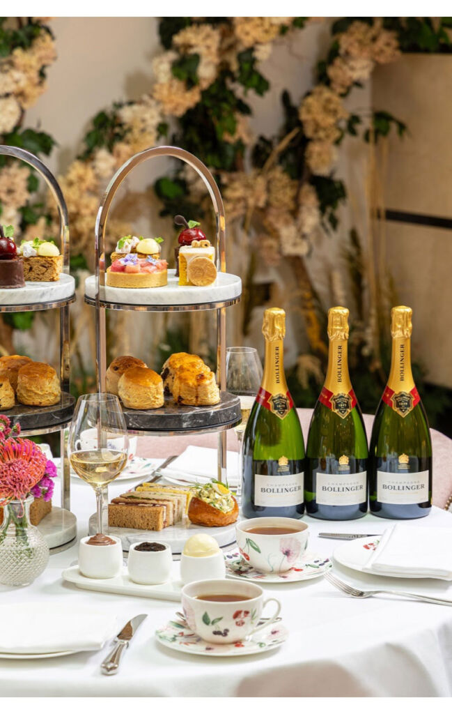 A photograph showing the scones on the tray and three bottles of champagne