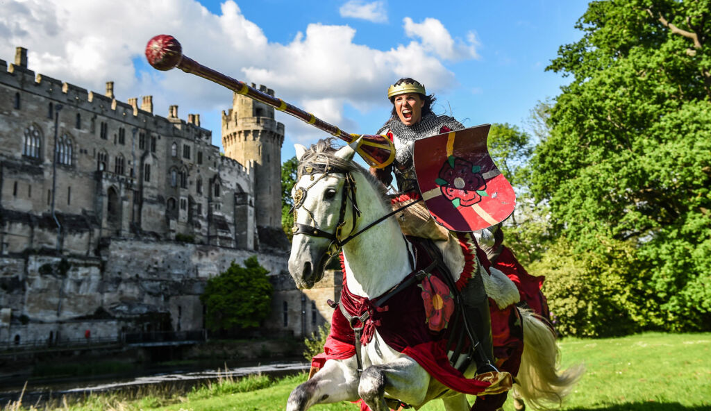 One of the lead jousters travelling at high speed on her horse