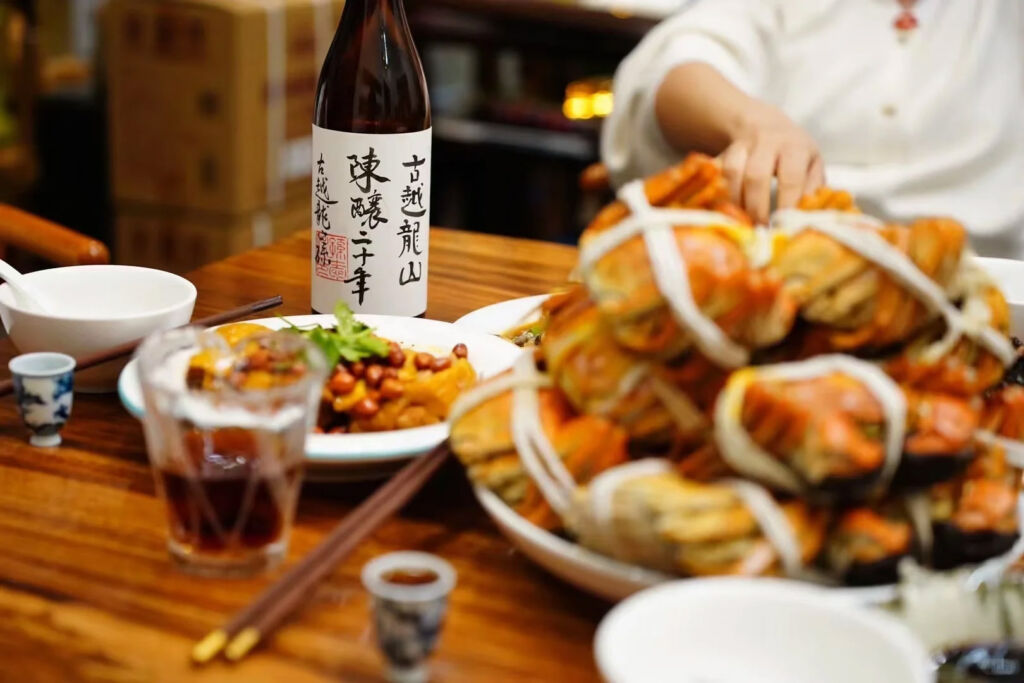 A bottle of Chinese wine next to plates of food