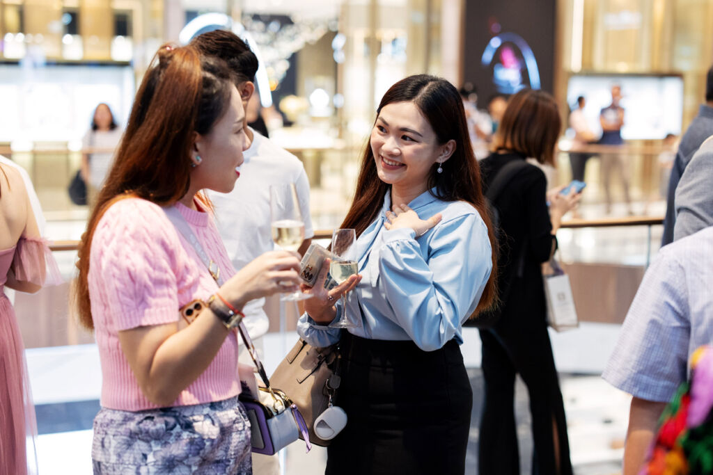 Two women in conversation at the opening of the store