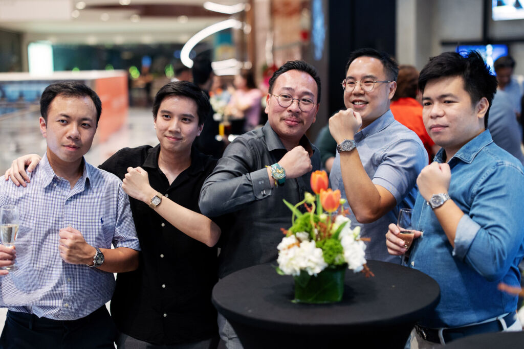 Five young men showing their watches at the opening of the new store in Kuala Lumpur