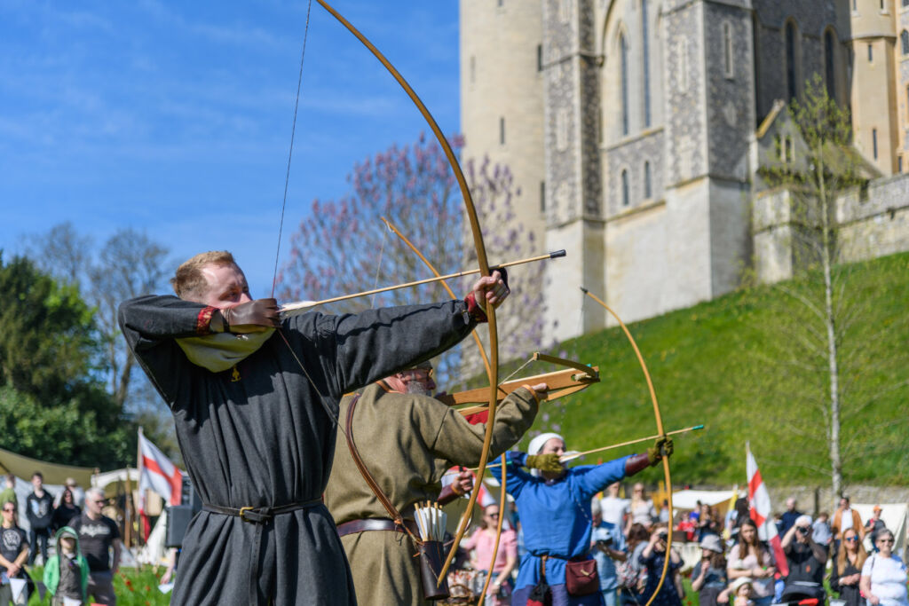 Archers in front of the castle's high walls