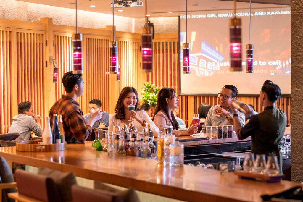 Guests enjoying cocktails at the bar