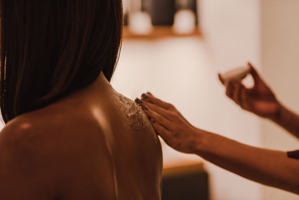 A woman having a rice scrub in a treatment room