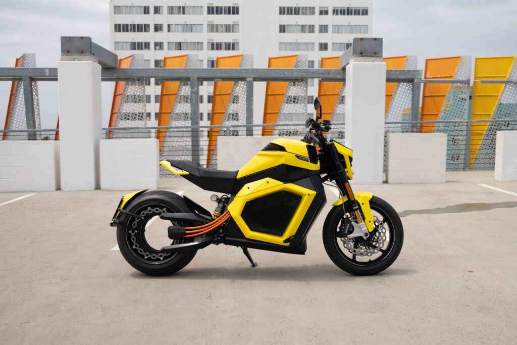 One of the motorcycles on top of a building in a yellow paint scheme