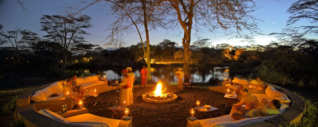 Guests relaxing by a campfire