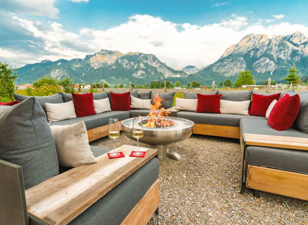 The outdoor terrace with snow capped mountains in the background