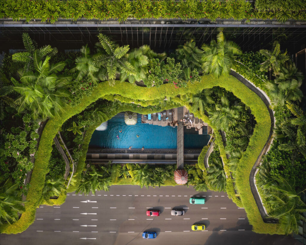 A top down view of the hotel showing the thick lush greenery and swimming pool