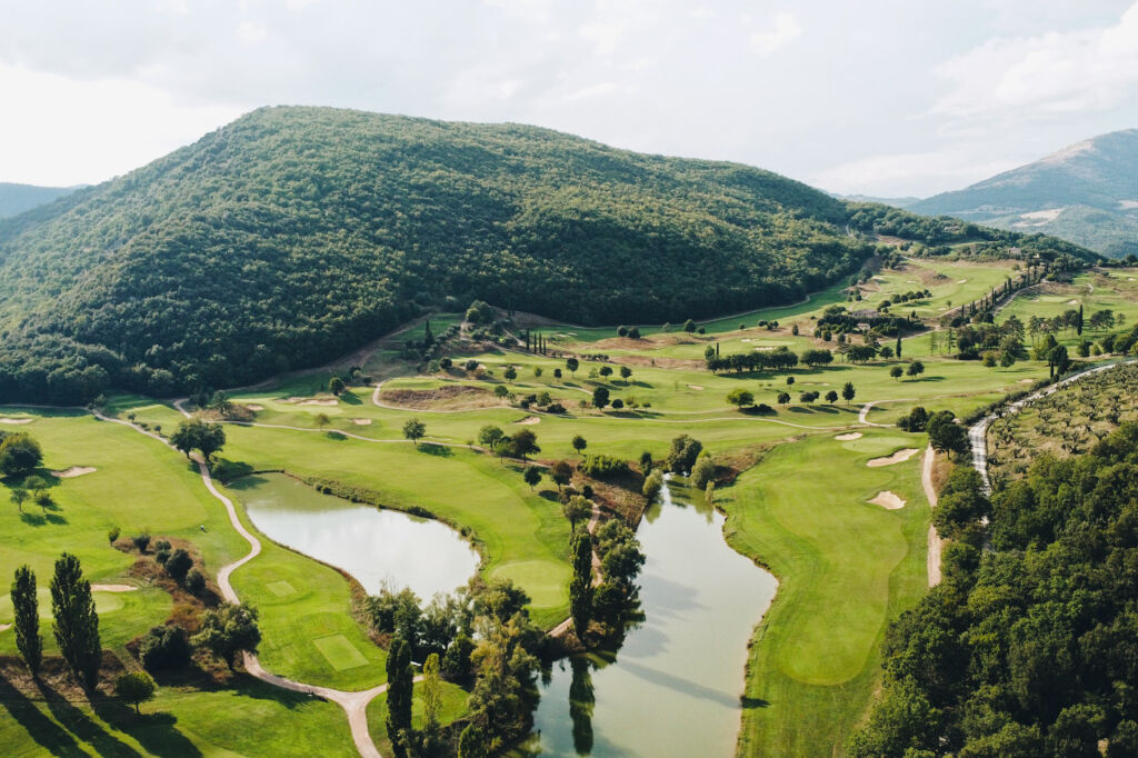 An elevated view of the course showing the surrounding hills and water features