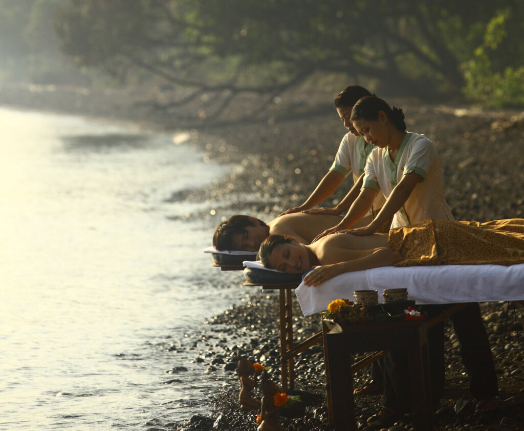 A couple enjoying a massage on the beach