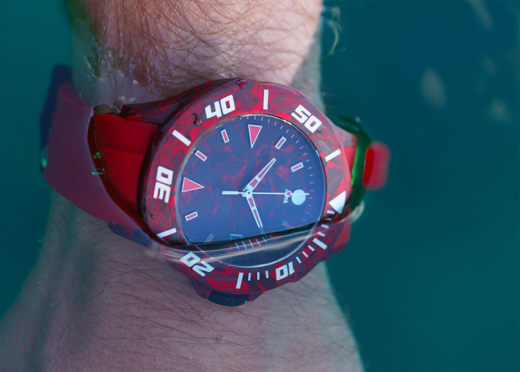 The red version being worn on the wrist