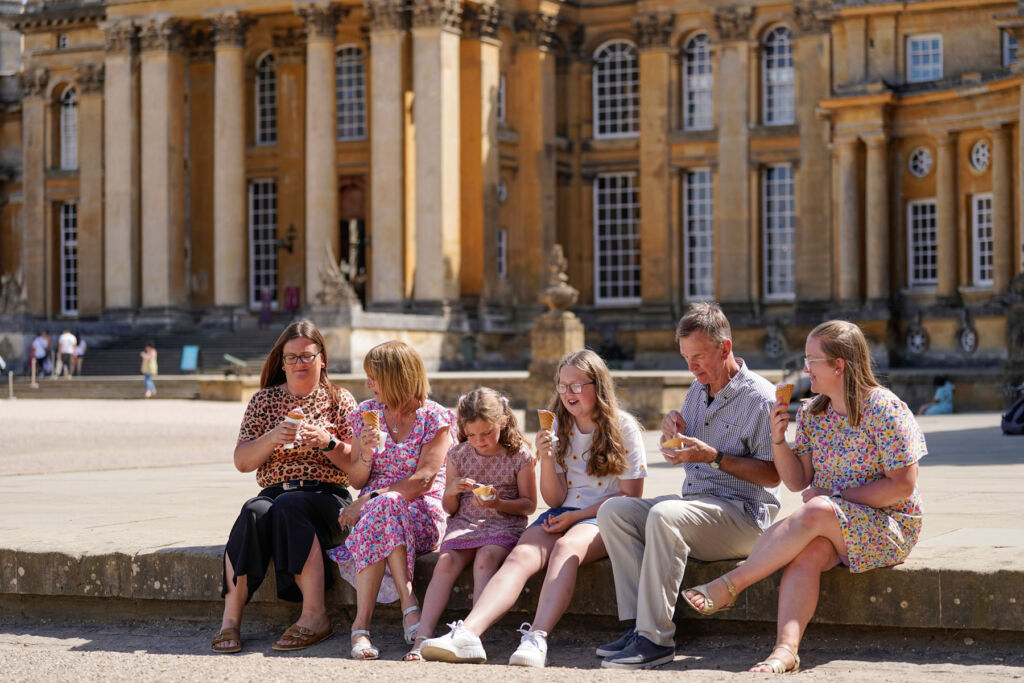 A family eating ice cream outside the historical property