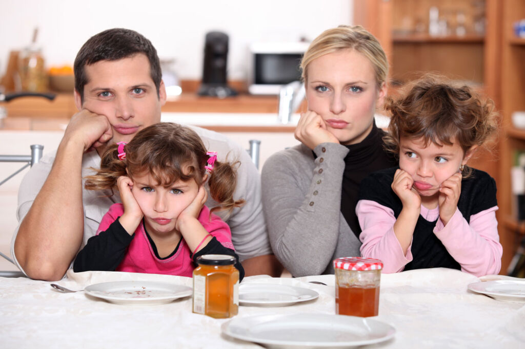 A family of four looking bored