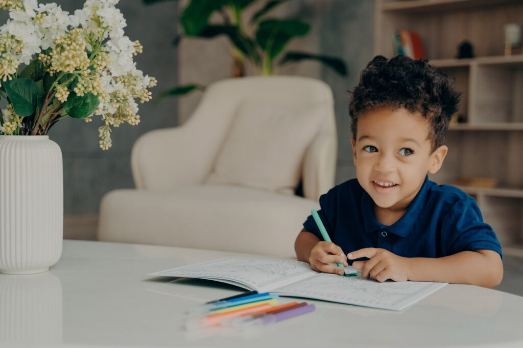 A young boy using a colouring book