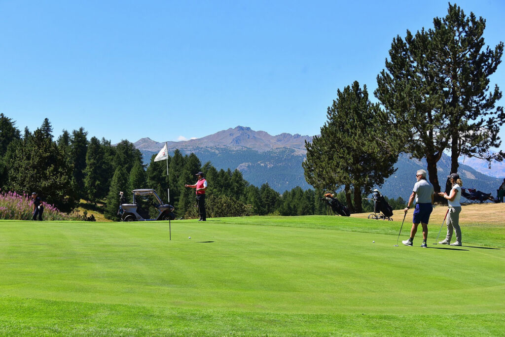 Golfers putting on one of the greens