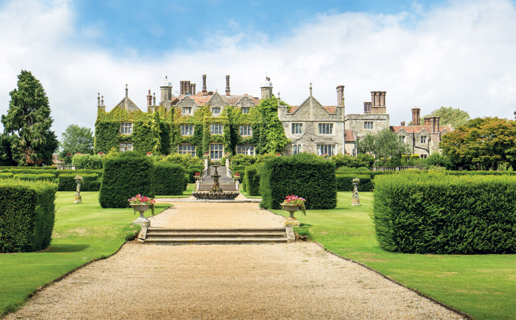 The exterior of Eastwell Manor in bright sunshine