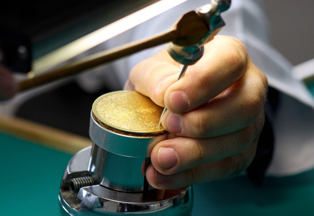 A photograph showing a team member working on the gold