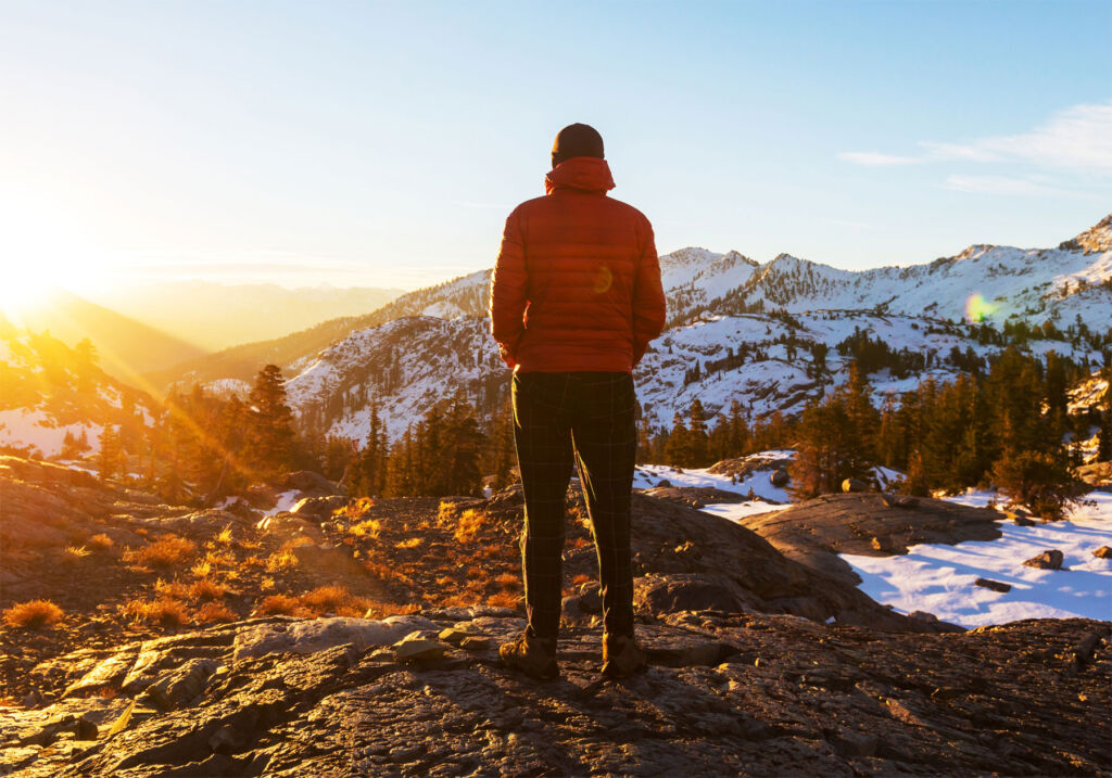 A man admiring the views from the top of a mountain