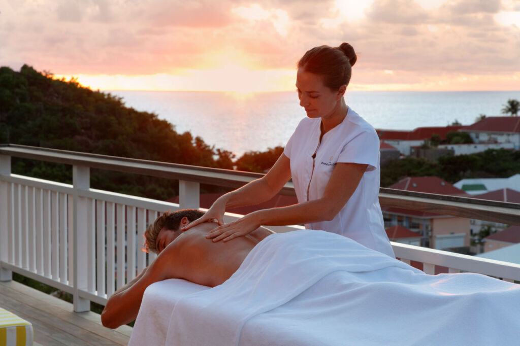 A guest enjoying a sunset massage outdoors
