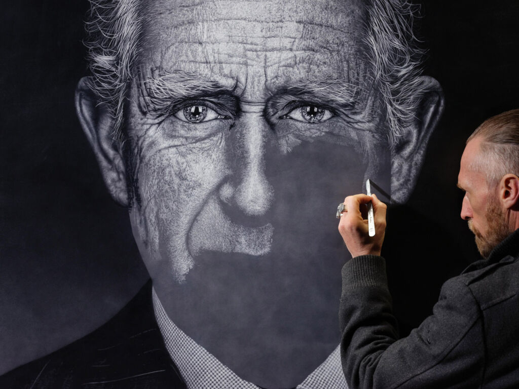 The artist working on the portrait