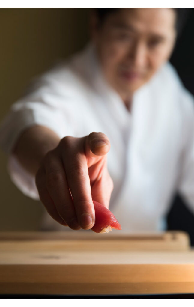 The chef pointing a finger at the photographer