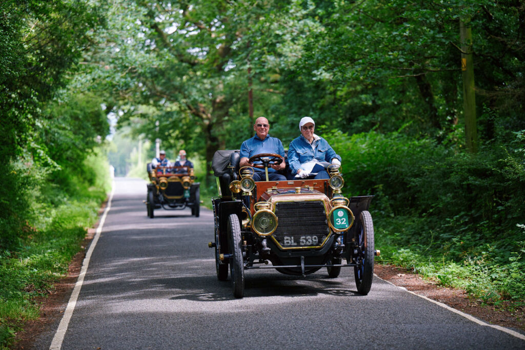 Cars driving along tree lined country roads