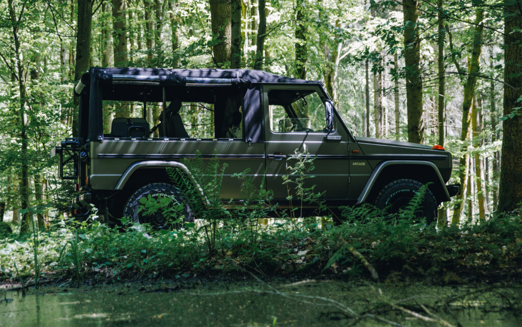 A side view of the car in a muddy forest 