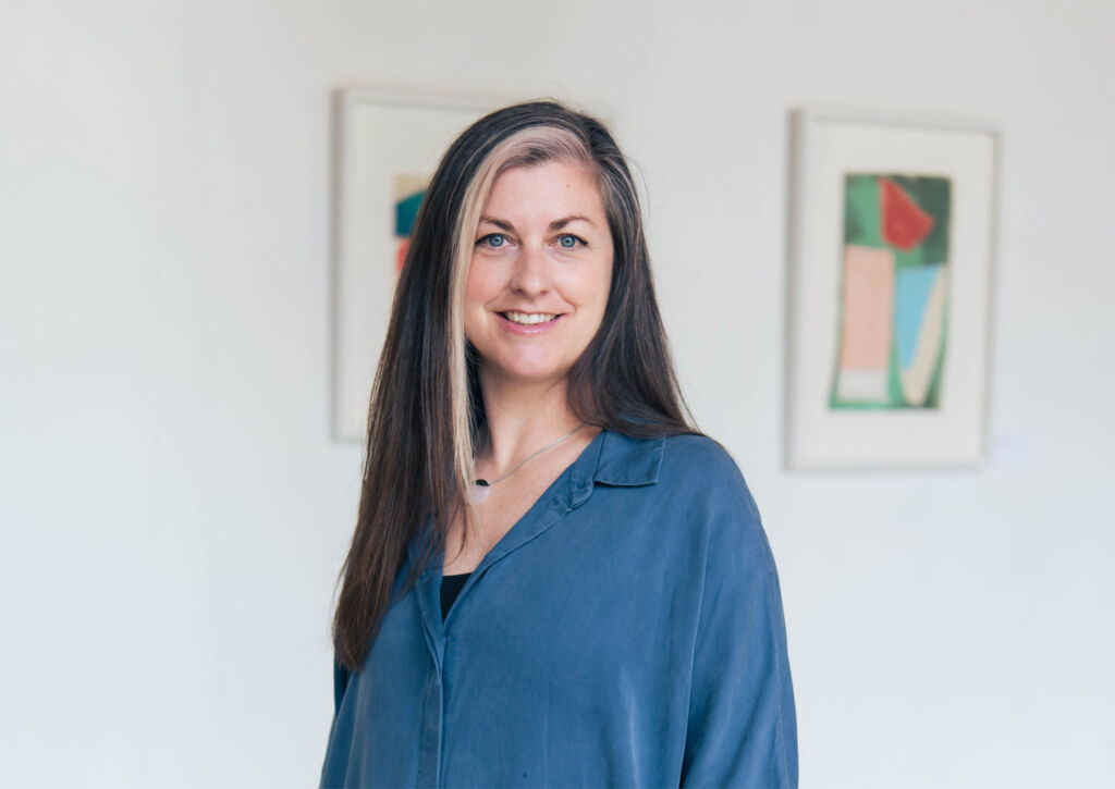 A photograph of Becca Pelly-Fry wearing a blue shirt