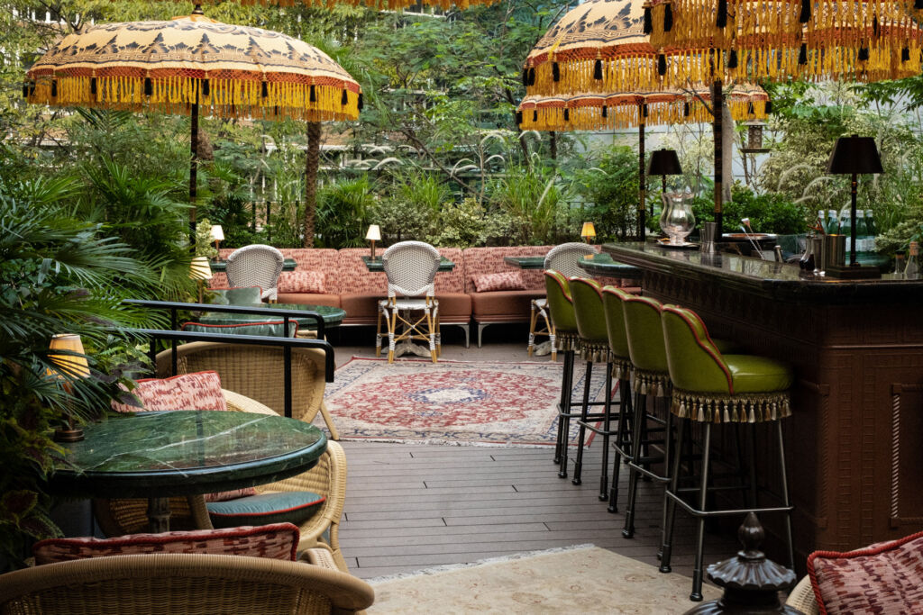 Tables with parasols and lush greenery in the garden