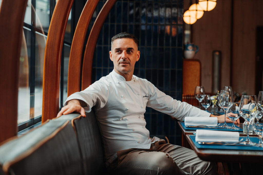 Chef Luca seated at one of the restaurant's tables