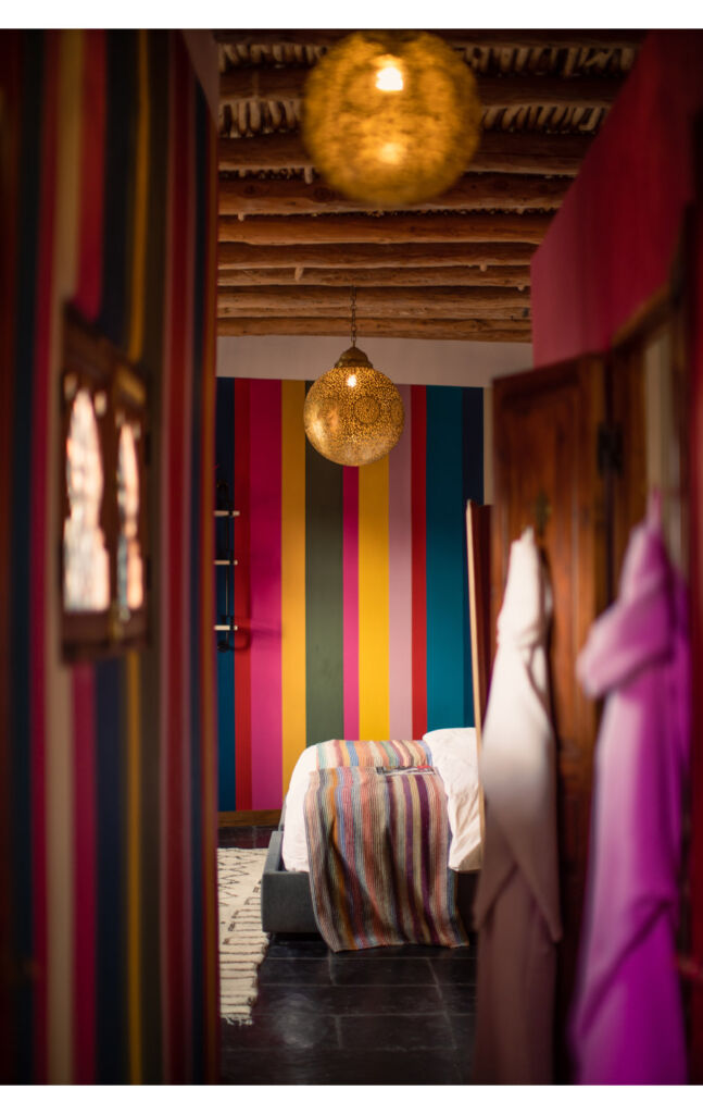 A photograph of one of the multi-coloured bedroom interiors